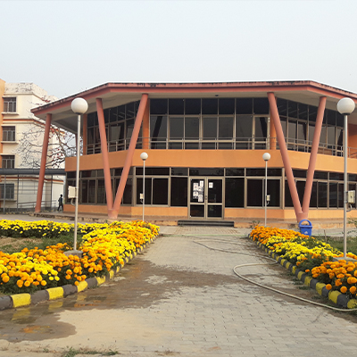 The NIBMG academic block at the Kalyani campus, framed by marigold flower beds